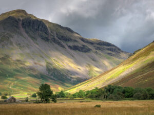 landscape photo looking up a valley with a stone farm house and tree in the foreground by Eric Drumm